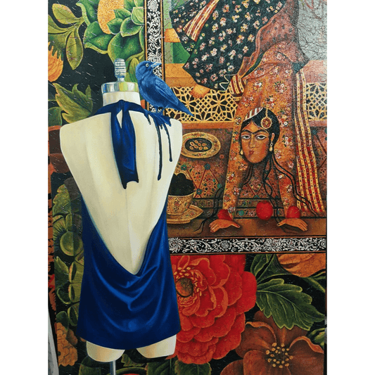 Mannequin in blue halter dress with bird on shoulder
